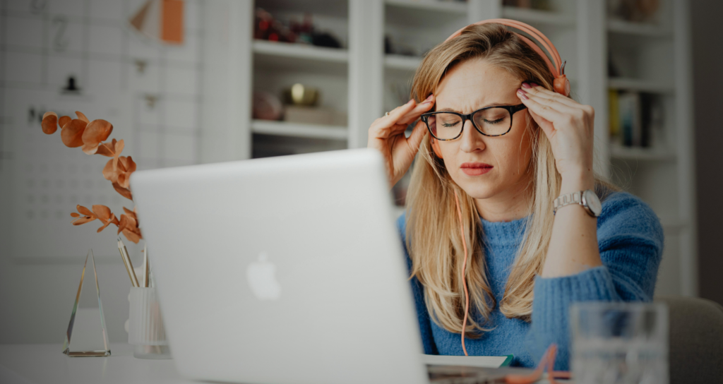 Woman with anxiety working on laptop, ketamine-related.