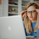 Woman with anxiety working on laptop, ketamine-related.